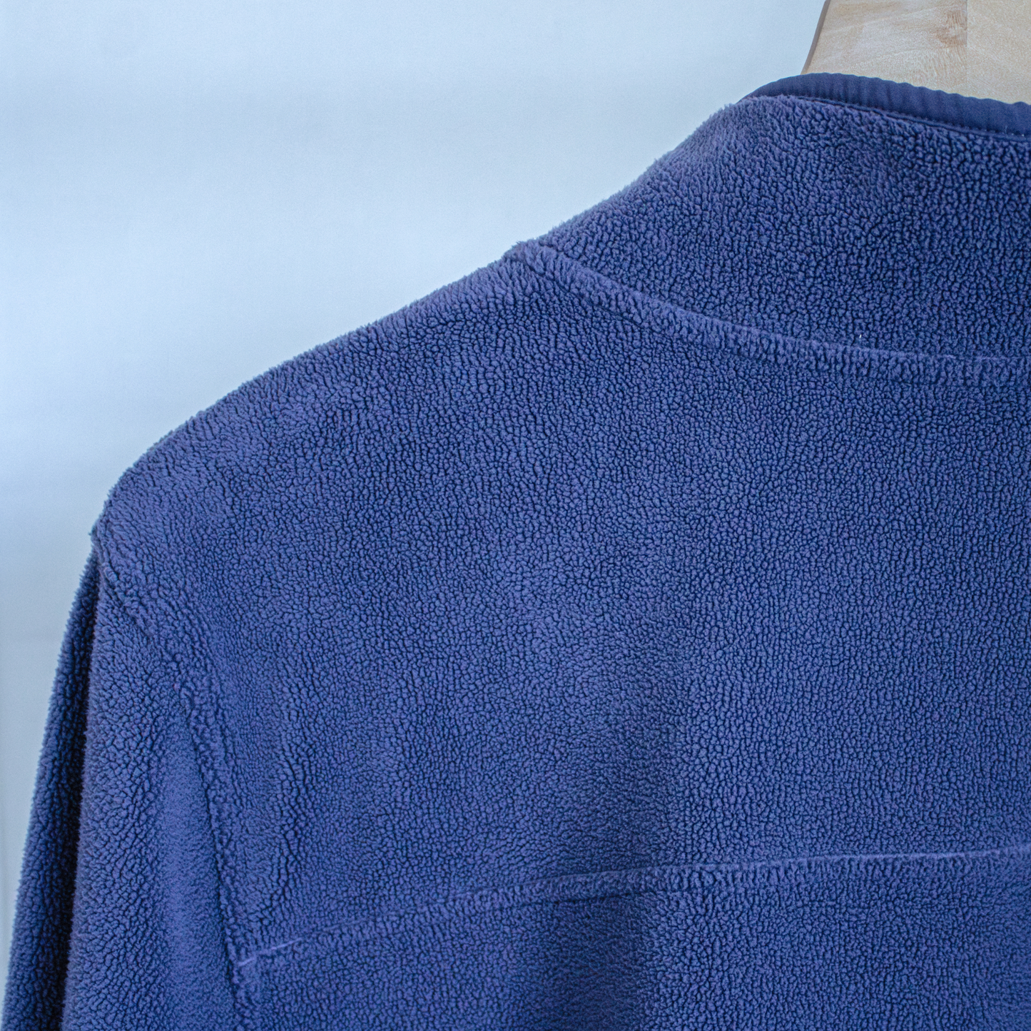 Blue fleece jacket on a light blue background