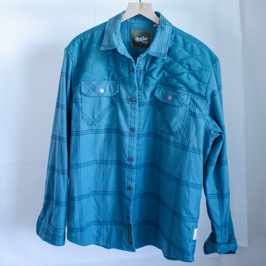 Howler Bros blue plaid shirt on a hanger against a white background